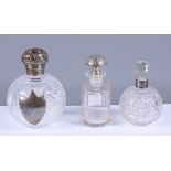 A hallmarked silver topped grenade cut glass scent bottle, 5" high, a silver collared scent bottle
