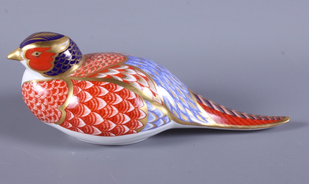 A Royal Crown Derby porcelain paperweight, in the form of a pheasant, with gold button to base, 6"