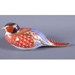 A Royal Crown Derby porcelain paperweight, in the form of a pheasant, with gold button to base, 6"