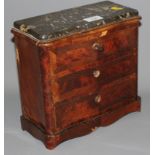 A late 19th century kingwood serpentine front apprentice chest with black marble top and three