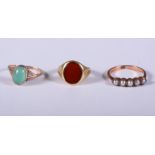 An 18ct gold and carnelian signet ring, size J, a 9ct gold and jadeite dress ring, size P, and a 9ct