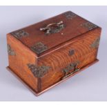 A late Victorian oak Gothic design cigar box with white metal mounts, the sliding lid opening to