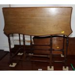 An Edwardian mahogany "spider" gate leg table with serpentine shaped leaves