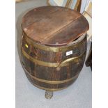 A brass coopered oak barrel with carry handles and cover, 19" high