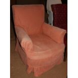 A deep seat arm easy chair with pink linen loose cover, on turned and castored supports