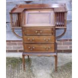 An Edwardian walnut fall front bureau with flanking bookcases over three graduated drawers, on