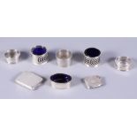 Three silver napkin rings, two silver mustard pots with glass liners, a silver salt cellar with