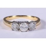 An 18ct gold and diamond three stone dress ring, 1.07ct approx, size N