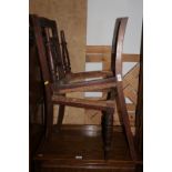 A set of six Edwardian carved walnut standard dining chairs with spindle backs (for restoration)