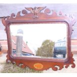 A mahogany framed wall mirror of Georgian design with eagle surmount and bevelled plate, 16" x 28"