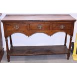 A 19th century oak dresser, the upper section fitted open shelves over three drawers and pot