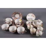 A George Jones & Sons porcelain set of six cups and saucers, decorated with flowers, together with a