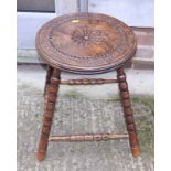 A 19th century chip carved elm circular top occasional table, on bobbin turned and stretchered