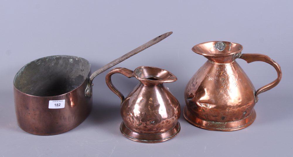 Two 19th century copper harvest jugs and a copper saucepan with iron handle