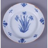 A Dutch 18th century tin glazed Delftware plate, painted with sprays of flowers, 9" dia