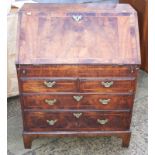 A George II walnut and banded fall front bureau, the interior fitted well and six drawers with