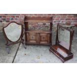 An Edwardian wall cupboard enclosed carved panel doors, a shield-shaped swing frame toilet mirror