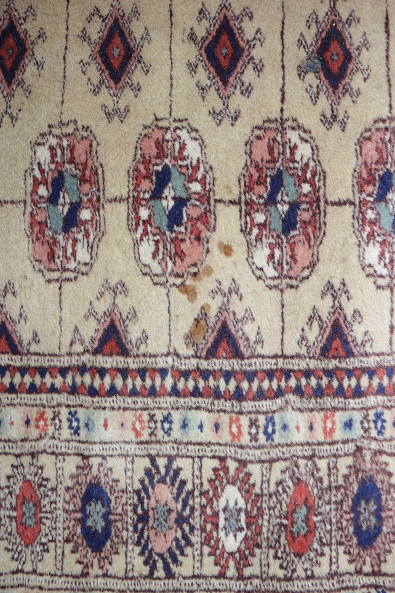A Bokhara runner of traditional design on camel ground, 38" x 120" approx