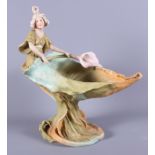 A Royal Dux painted porcelain naturalistic pedestal bowl, surmounted a woman, 12" high