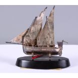 A 925 silver model of a Maltese Dghajsa (traditional boat), on oval ebonised base