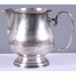 An early 20th century Christofle silver plated jug, bulbous body, 'C' scroll handle, on circular