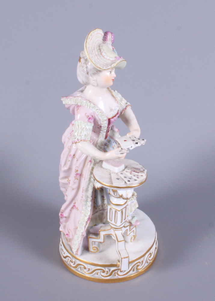 A late 19th century Meissen porcelain figure of a standing woman in 19th century costume by a tripod - Image 2 of 5