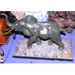 An early to mid 20th century bronze model of a standing elephant, on rectangular marble plinth