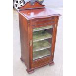 An Edwardian mahogany music cabinet enclosed glazed panel door, on splay supports, 19" wide