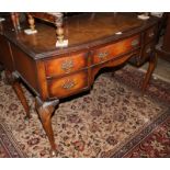 A 1930s walnut and banded bowfront dressing table, fitted five drawers, on cabriole supports