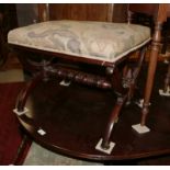 A late Victorian mahogany 'X' frame stool with embroidered seat, 21" long