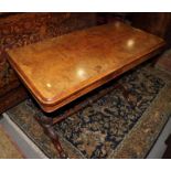 A Victorian burr walnut fold-over top card table, on turned and carved twin column and splay