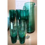 A set of six green wine glasses, a pair of green glass tumblers and a matching jug