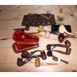 A smoker's brass mounted pipe rack and a collection of pipes, various