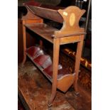 An Edwardian mahogany and inlaid book trough, on castored supports, 21" wide