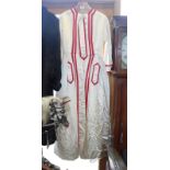 A cream silk "military" style dress with red facings