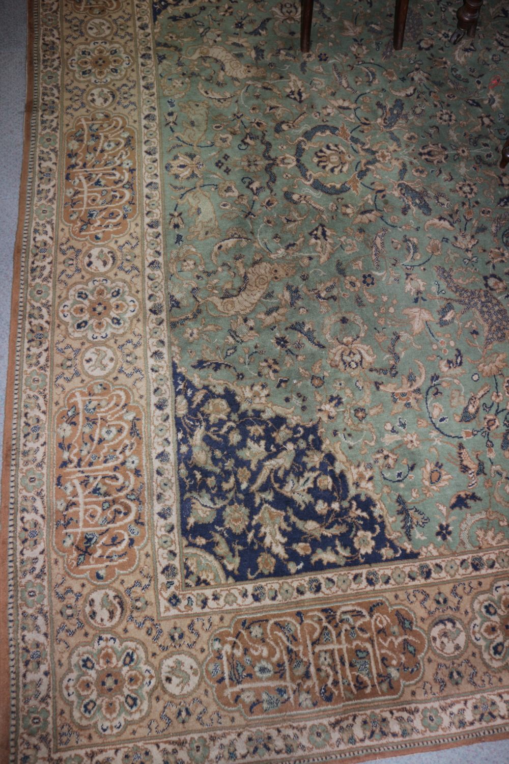 A Persian design bordered carpet, green field decorated foliage and animals, central lobed