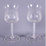 A pair of early 20th century air-twist stem glasses of Georgian design, etched with vines and