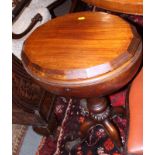 A late 19th century walnut teapoy, the hinged lid opening to sectioned compartments, on carved