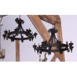 *A pair of black japanned wrought iron circular eight-light chandeliers of 16th century design