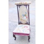 A Victorian rosewood framed prie-dieu chair, upholstered in a floral gros point with twist turned