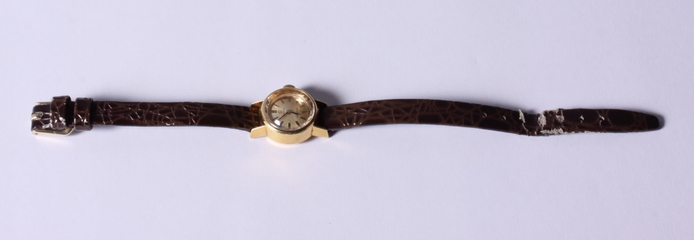 A lady's 18ct gold cased Omega Ladymatic wristwatch with silvered dial and baton numerals on brown