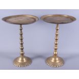 A pair of brass circular tray top miniature tables, 11" dia