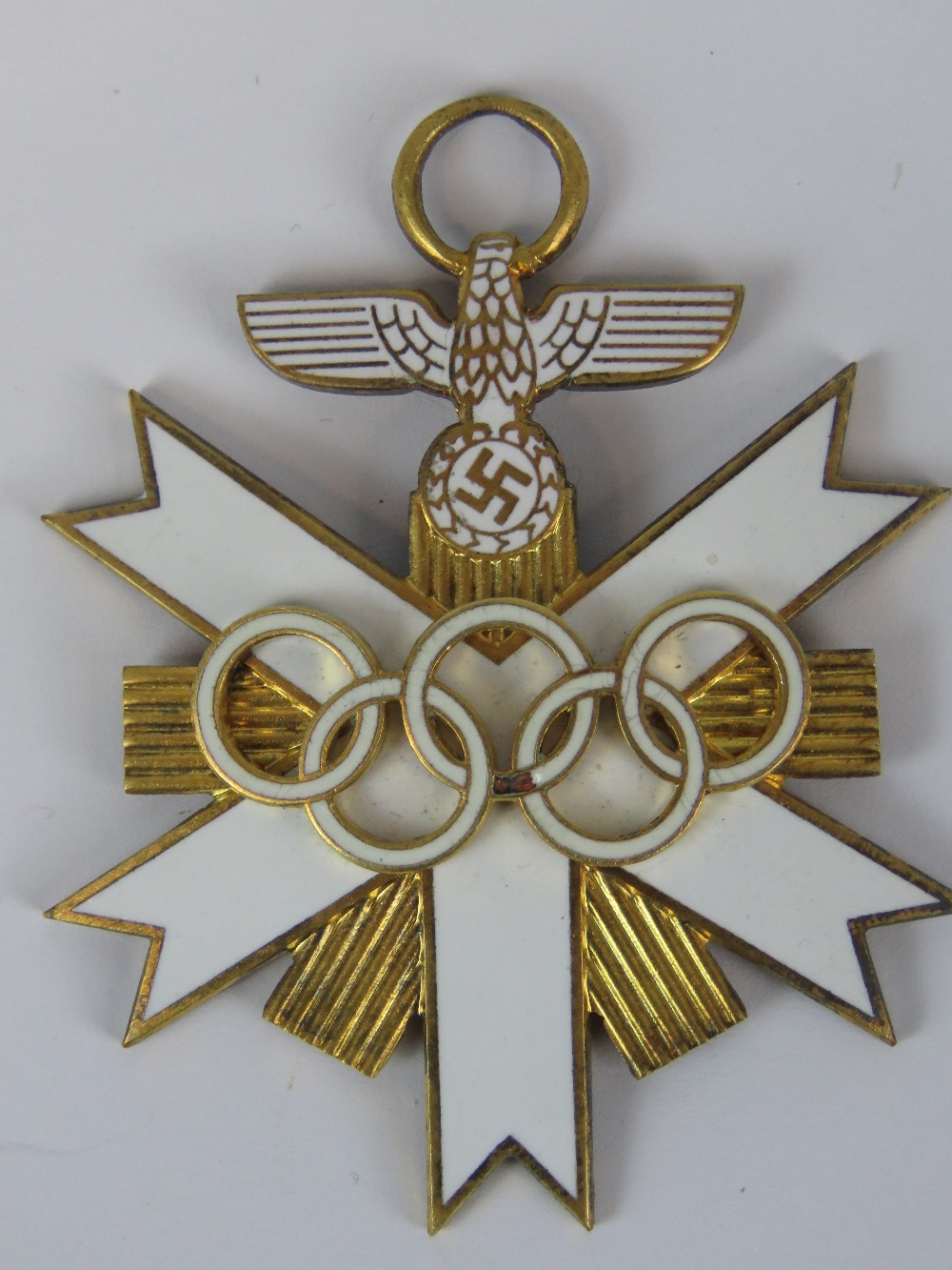 A reproduction Nazi German enamelled Olympic grand cross; 6.5cm long.