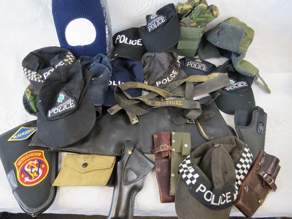 A selection of police hats and gun accessories.