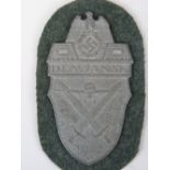 A WW2 Nazi German "Demjansk 1942" style white metal shield on cloth; 9cm long.