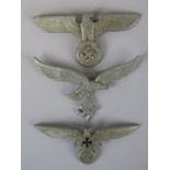 Three WW2 Nazi German white metal cap badges; with two stamped "A" verso.