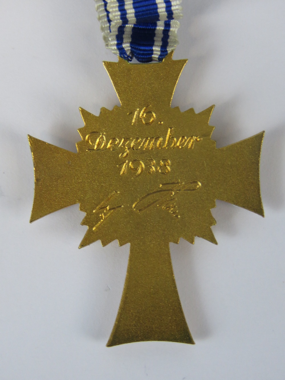 A Nazi German, Mothers' cross (4.2cm long)with blue and white ribbon, inscribed verso "16. - Image 2 of 2