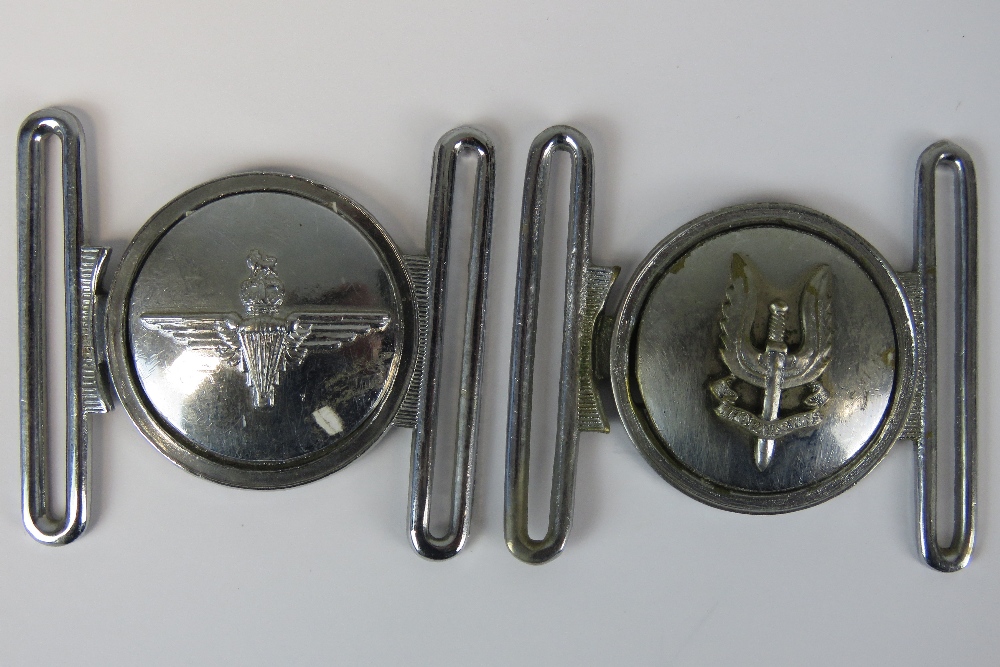 A reproduction SAS belt buckle together with a reproduction paratrooper buckle.