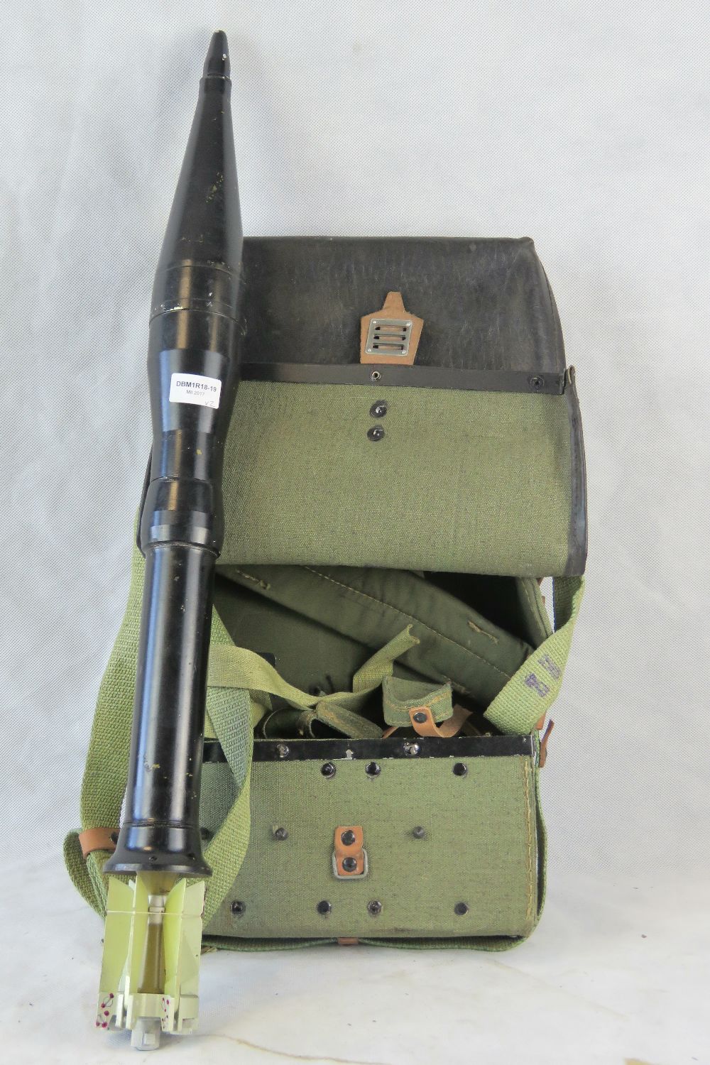 An inert Soviet RPG rocket and carry bag (two items).