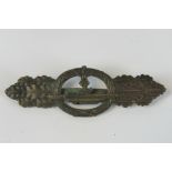 A WW2 Nazi German U-boat clasp; "Entwurf Peekhaus Aus... Schwerin Berlin 68" stamped verso; 7.